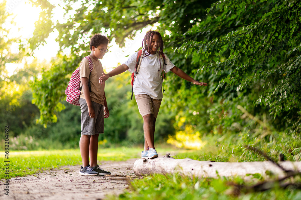 Fototapeta premium Two teens having a walk in the park after school