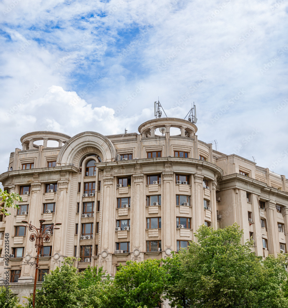 Fototapeta premium 30-05-2025 Bucharest, Romania. Panoramic summer view Palace Parliament among green meadow.