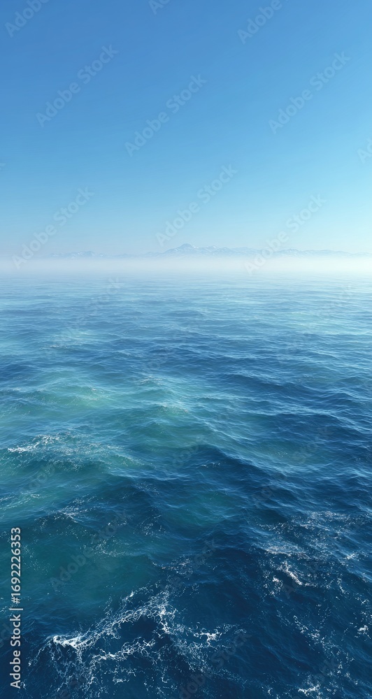 Fototapeta premium Calm ocean surface meeting a hazy, distant horizon