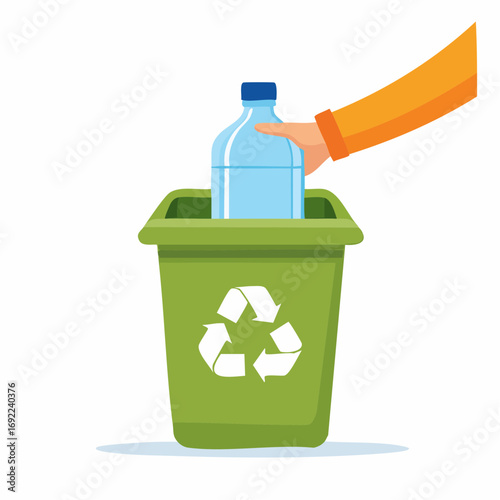 Hand Placing Plastic Bottle Into Green Recycling Bin