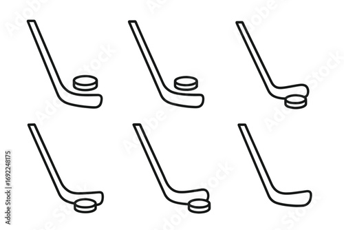 Set of hockey sticks and pucks in different positions