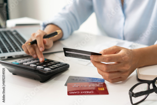 Asian woman checking bills, taxes, bank account balance and calculating credit card expenses. Family account concept. Close up