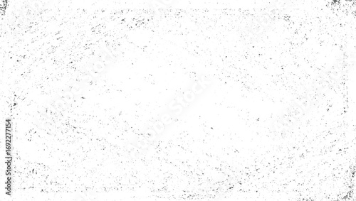 A white surface with scattered dark speckles and abstract lines creating a textured pattern.