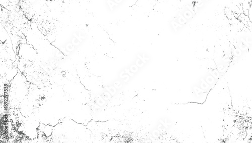 A white surface with dark gray cracks and speckles creating a distressed texture.