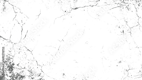 A white surface with scattered gray cracks and speckles creating a textured background.