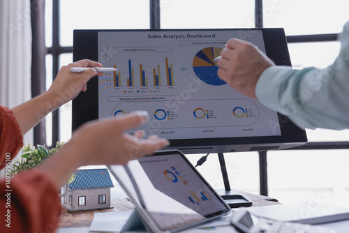 Fotografie Business colleagues discussing sales performance using data visualization tools