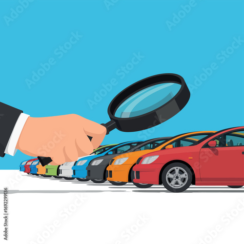 Hand holding magnifying glass over row of colorful cars for inspection