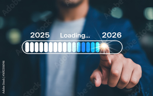 Progress and transition from 2025 to 2026 concept. A person pointing to loading bar transitioning from 2025 to 2026, progress, future planning, and new year goals. annual planning and business growth.