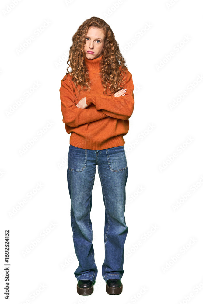 Obraz premium Full-body redhead portrait unhappy looking in camera with sarcastic expression.