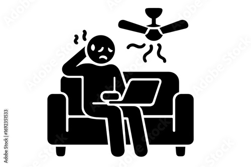 Person feeling hot and uncomfortable while working on laptop at home under a ceiling fan during a heatwave