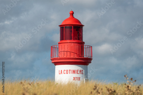 La Cotinière Lighthouse on a sunny day in summer. Beautiful red and white french lighthouse located in La Cotinière, Oléron island, Charente-Martime in France.