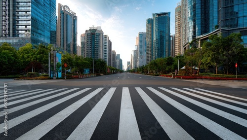 Fototapeta Naklejka Na Ścianę i Meble -  Empty city street, pedestrian crossing, modern skyscrapers