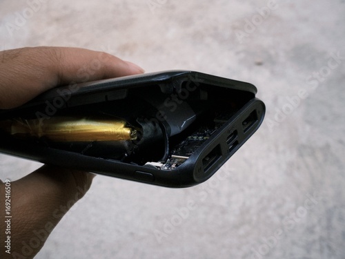 Damaged exploded powerbank smartphone charger due to battery swelling