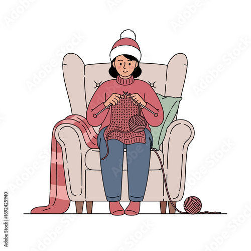 Person knitting in armchair with blanket and yarn.