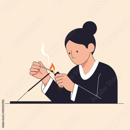 Person lighting incense stick with a match.