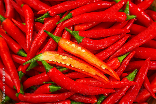 Fresh Red Chili Peppers with Cut Open Pepper Showing Seeds - Spicy Cooking Ingredients
