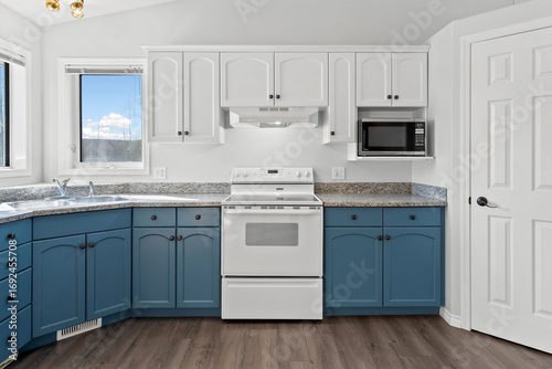 Kitchen with blue cabinets and white appliances