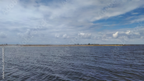 Waves of pure blue kiss the golden sands of Castelhanos Beach on Boipeba Island, Brazil.