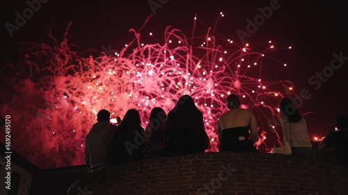 Cinematic shot of people enjoying stunning fireworks in the night sky, festive mood, holiday celebration, New Year’s Eve, fiesta, carnival,, joyful emotions, city fest, slow