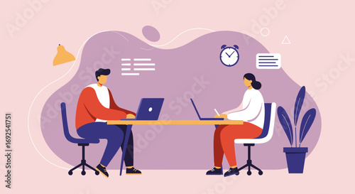 Two professionals working efficiently on laptops at a shared desk, embodying remote collaboration, office productivity, and modern business operations.