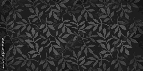 Dark seamless pattern of overlapping grey branches with leaves on a textured black background