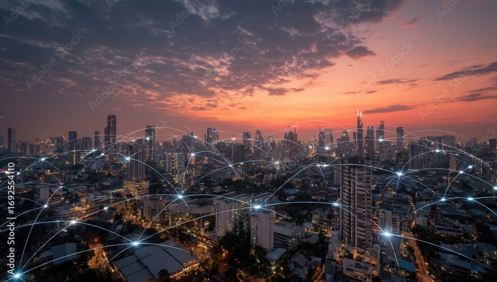 Obraz premium Aerial view of a city at sunset, network lines connecting buildings