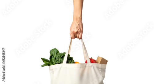 a hand holds a sustainable tote bag fresh produce, healthy choices, and ecofriendly living, isolated on transparent background