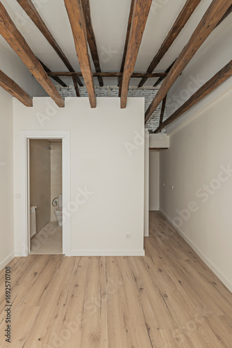 Large empty room with a stunning ceiling of centuries-old solid oak beams that show history in every grain and natural knot