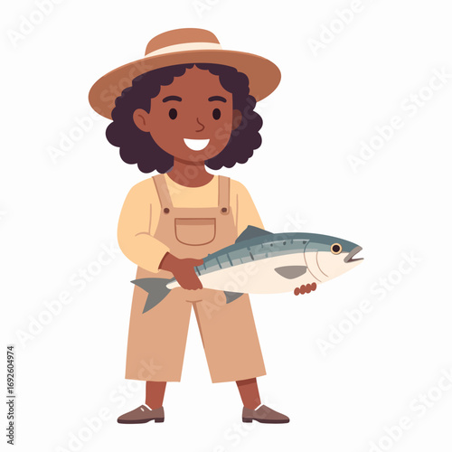 A young girl in overalls holds a large fish, smiling cheerfully.