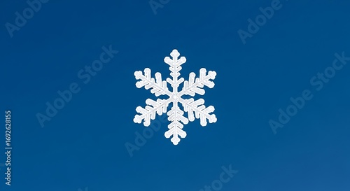 Single white snowflake on a blue background.