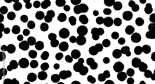 An abstract pattern of irregular black dots scattered across a clean white background creating a visually engaging organic texture