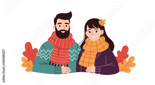 Happy couple enjoying the autumn season dressed in warm sweaters and scarves surrounded by colorful fall leaves