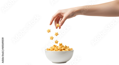 Serving star-shaped cereal into a white bowl against a black backdrop