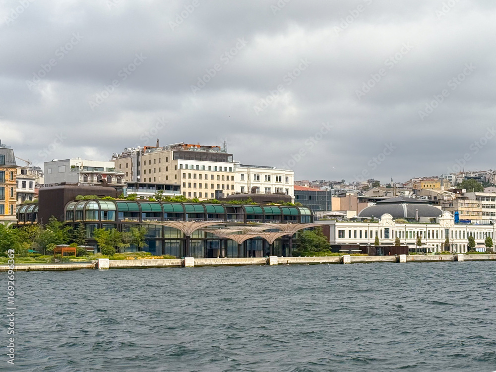 Obraz premium Modern glass buildings and urban development near Bosphorus. Contemporary architecture, business, and lifestyle in Istanbul.