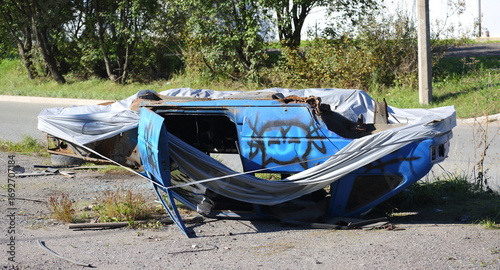 An upside-down, mangled blue car lies on the side of the road, Krzhizhanovsky Street, Saint Petersburg, Russia, September 8, 2025