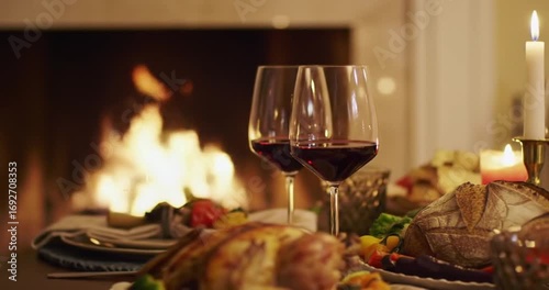 Elegant dinner setting with wine and fireplace glow