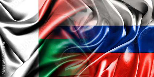 The national flags of Russia and Madagascar are combined into one and placed side by side on a fluttering cotton background. Flags.