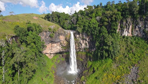 Aerial view of a waterfall cascading into a valley