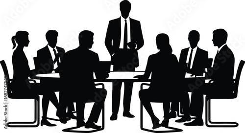 Silhouetted Business Professionals Engaged in a Boardroom Meeting Presentation with One Person Standing and Six People Sitting at the Table