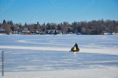 Snowmobile in frozen lake during winter