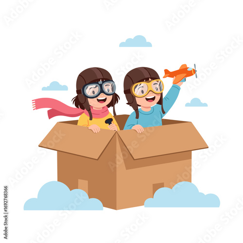 Two young adventurous girls imagining flying their cardboard box airplane through the sky