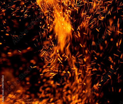 A fire is burning and the smoke is creating a lot of sparks