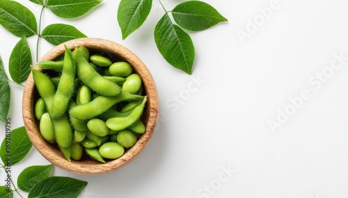 Wallpaper Mural Fresh edamame pods in a wooden bowl, surrounded by green leaves on a white background Torontodigital.ca