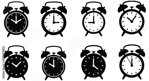 eight classic alarm clocks showing various times