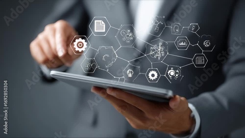 Professional interacts with digital tablet displaying innovative technology icons in a modern business environment