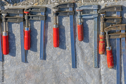 Wall Mural Many Metal Clamps With Red Handle Woodwork Device Tools Set