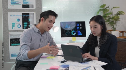 Professional team analyzing financial charts, working together on data driven project with digital tools in contemporary office environment