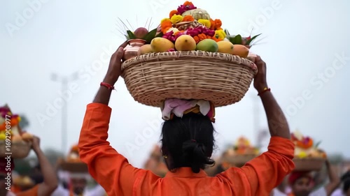 A devotee carries a basket of offerings on their head during the chhath puja festival in india, showcasing tradition and devotion in a vibrant cultural setting chhath puja