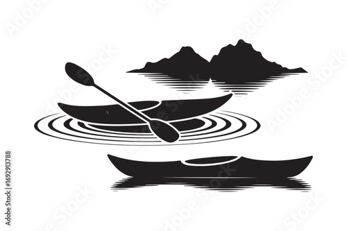 Kayaks and mountains silhouette on water