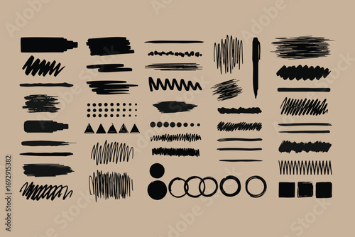 Collection of hand drawn black brush strokes and shapes on kraft paper